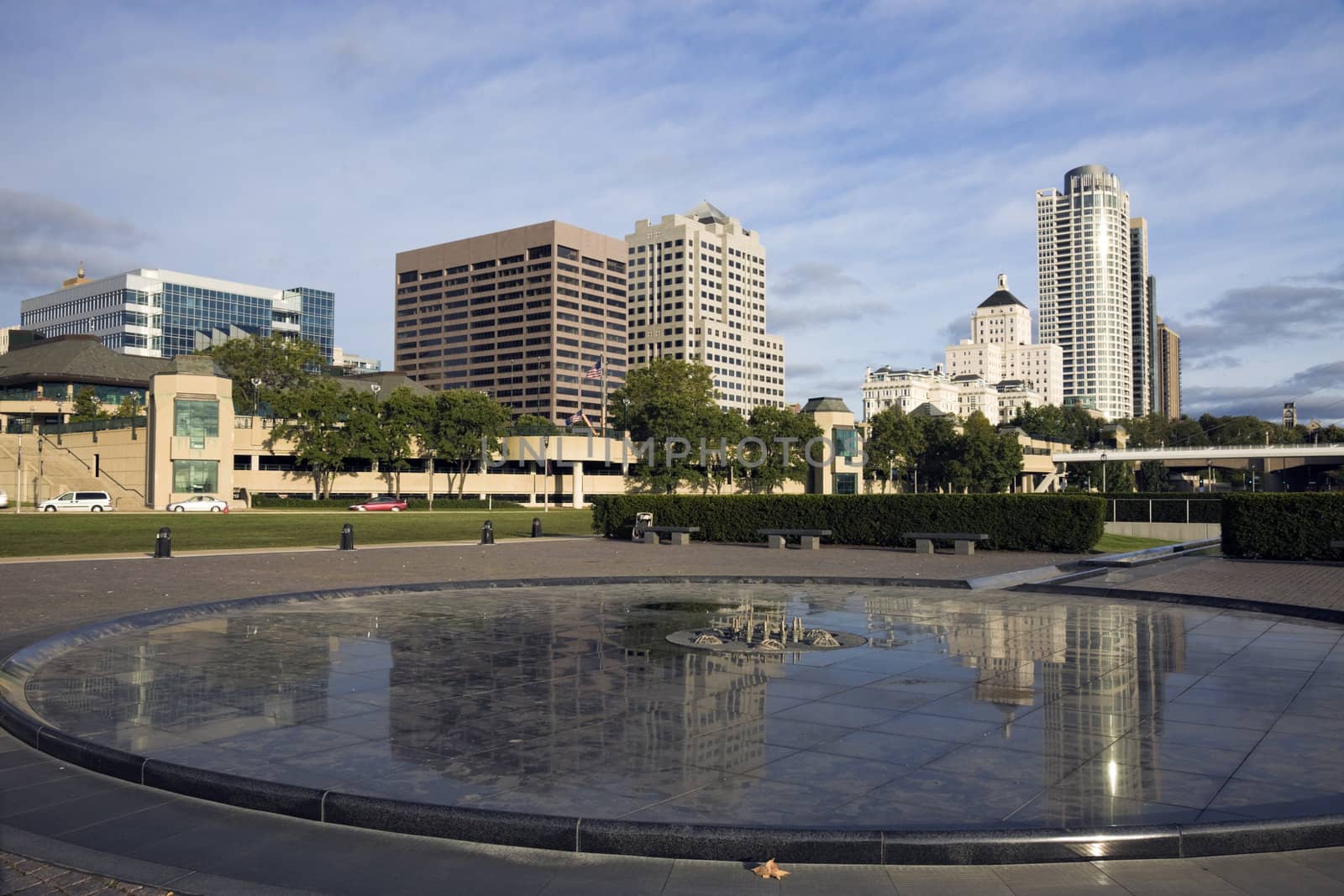 Downtown Milwaukee reflected in fountain.