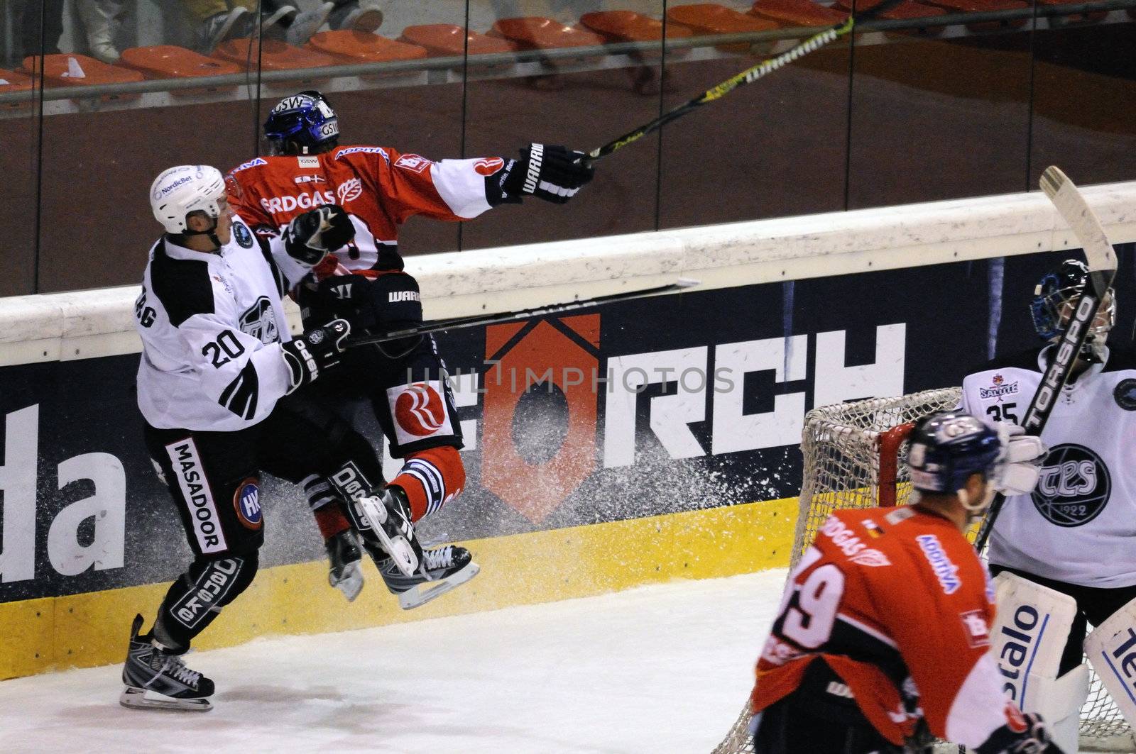 ZELL AM SEE; AUSTRIA - SEPTEMBER 3: Red Bull Salute Tournament. Jens Skalberg of TPS Turku gets hit hard by Berlin player.  Game between TPS Turku and Eisbaeren Berlin  (Result 1-4) on September 3, 2010, at the hockey rink of Zell am See