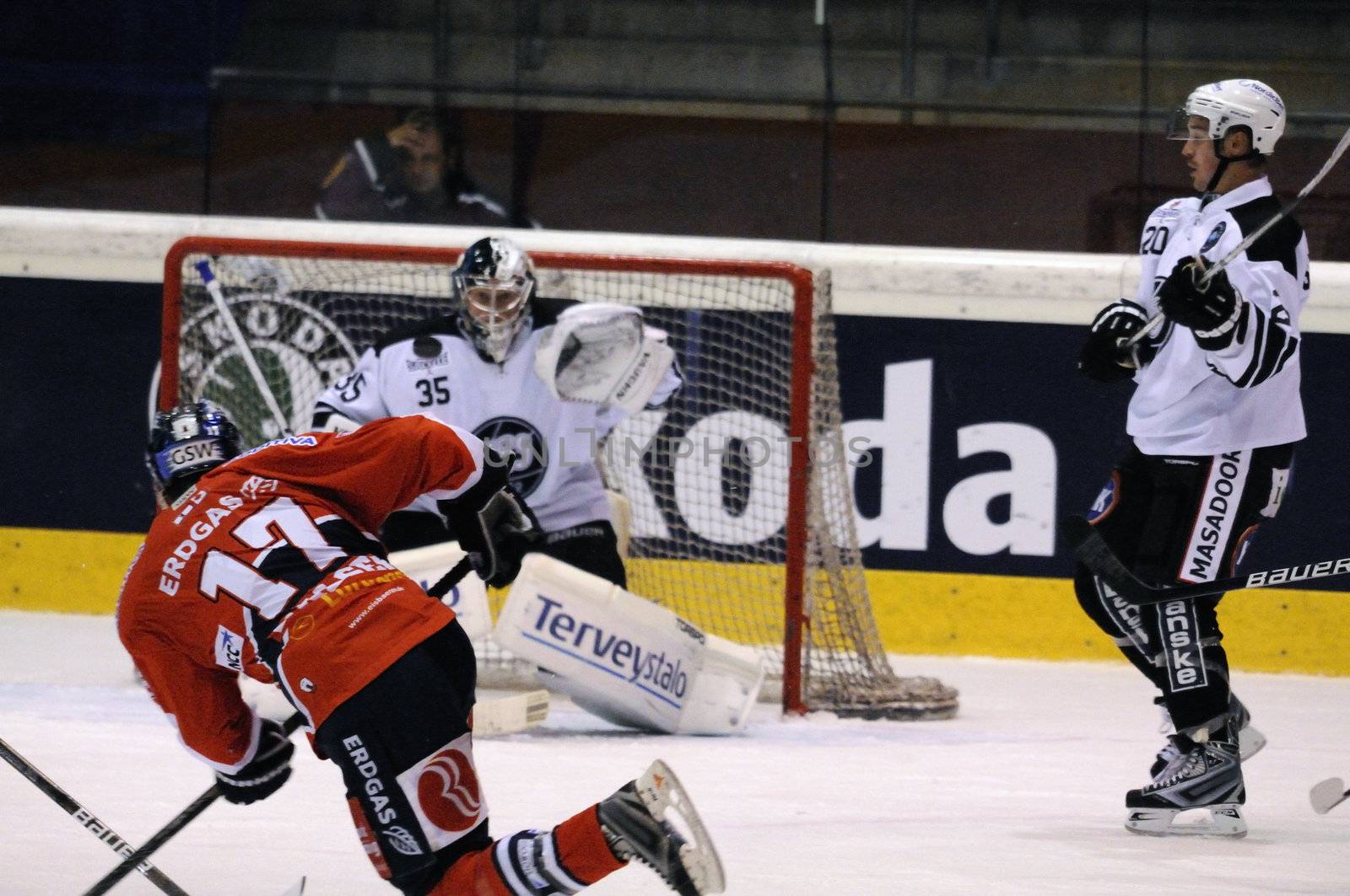 ZELL AM SEE; AUSTRIA - SEPTEMBER 3: Red Bull Salute Tournament. Derrick Walser (Berlin) shooting on goalie Atte Engren.  Game between TPS Turku and Eisbaeren Berlin  (Result 1-4) on September 3, 2010, at the hockey rink of Zell am See