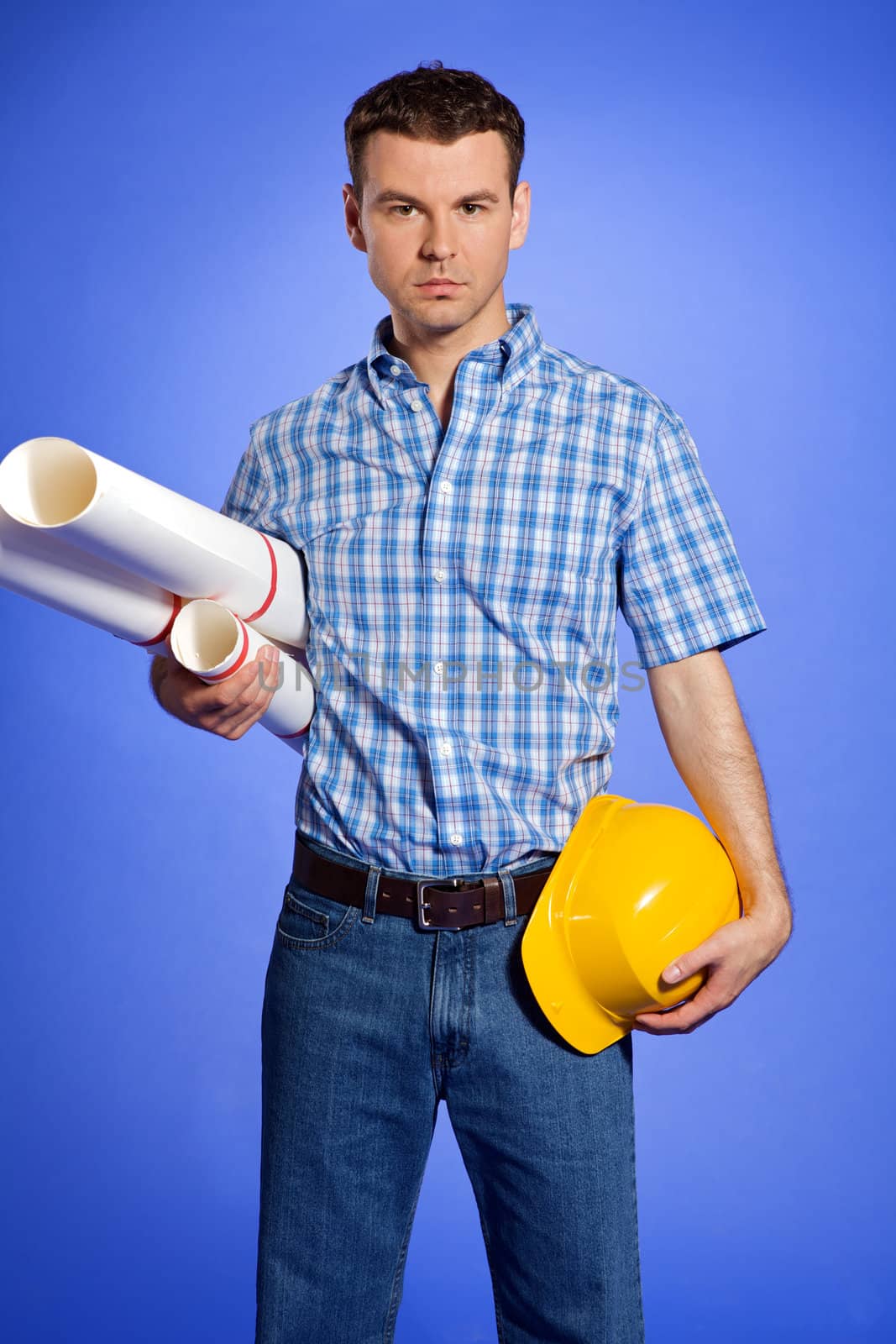 Portrait of architect holding blueprint and hardhat