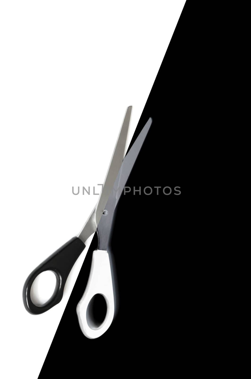 scissors cutting or dividing a black and white copyspace area