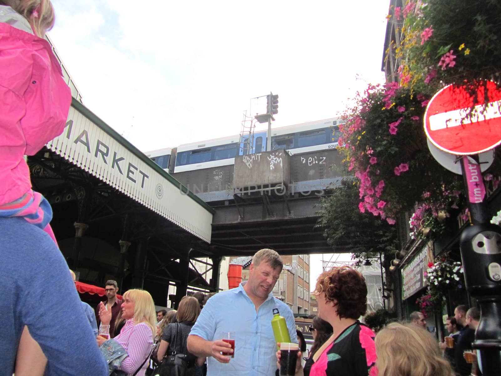 LONDON - AUGUST 14: Unidentified visitors at Borough Market on August 14, 2010 in London. Borough Market is one of the largest gourmet food markets in London.                       