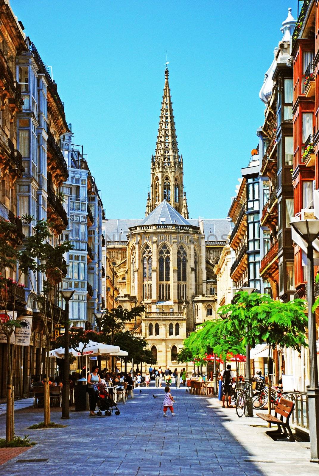 On this image we can see a big avenue with a cathedral in the end. It's in san sebastian in spain, the cathedral is named "catedral del buen pastor" in spanish.