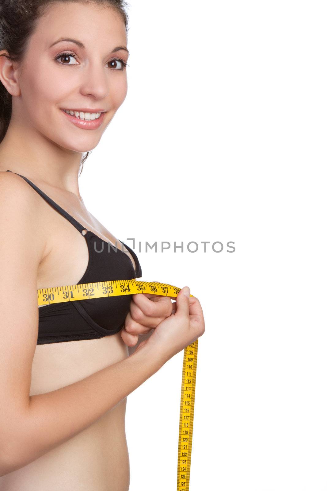 Beautiful young woman measuring bust