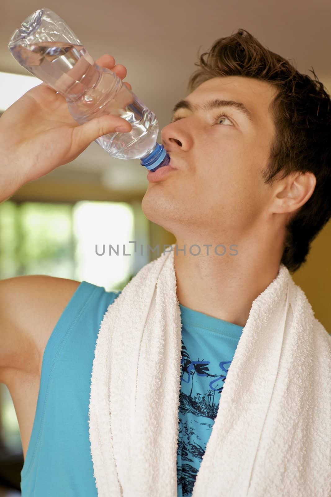 A young man drinking a bottle of water