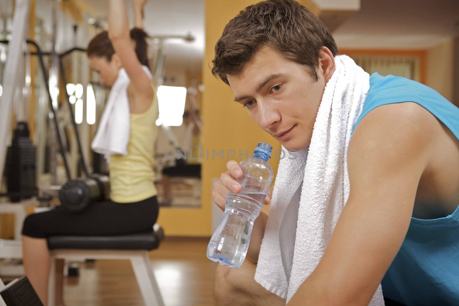 Portrait of young man taking a rest in gym