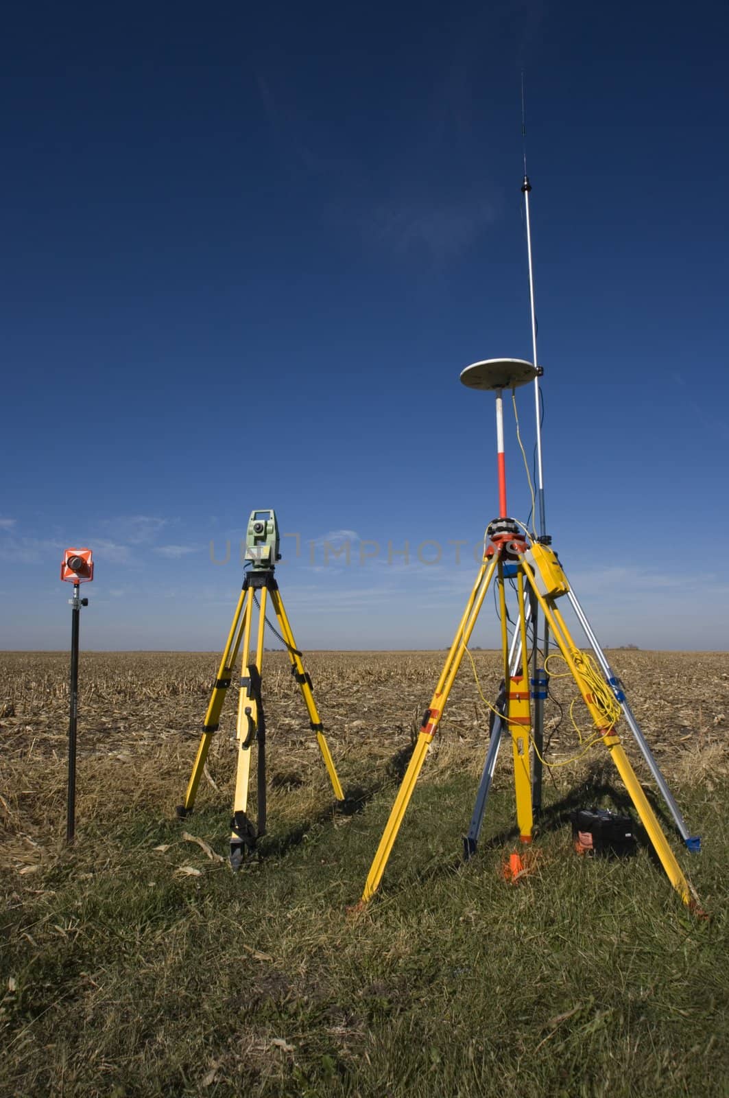 GPS unit, Total station and Prism set in the field.