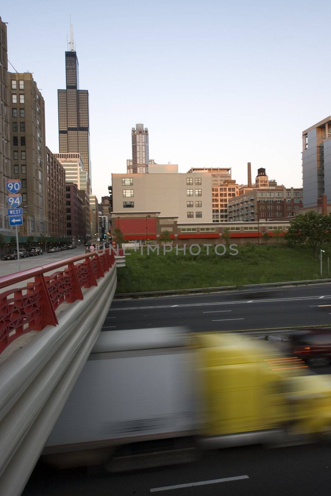 Blurred semi-truck driving expressway in downtown Chicago