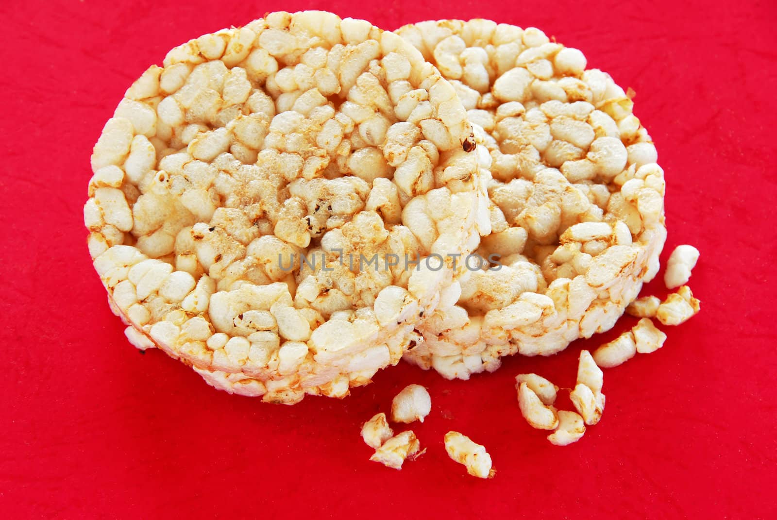 two round rice cakes over red background