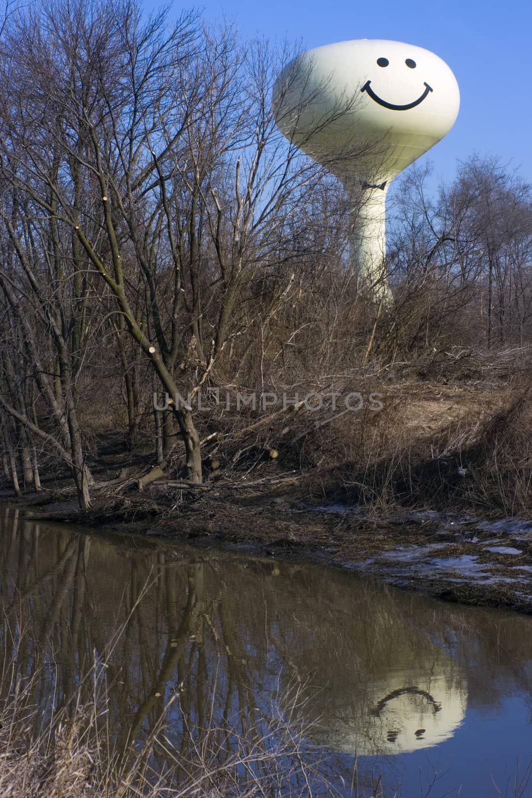 Smiling Water Tower reflected in river.