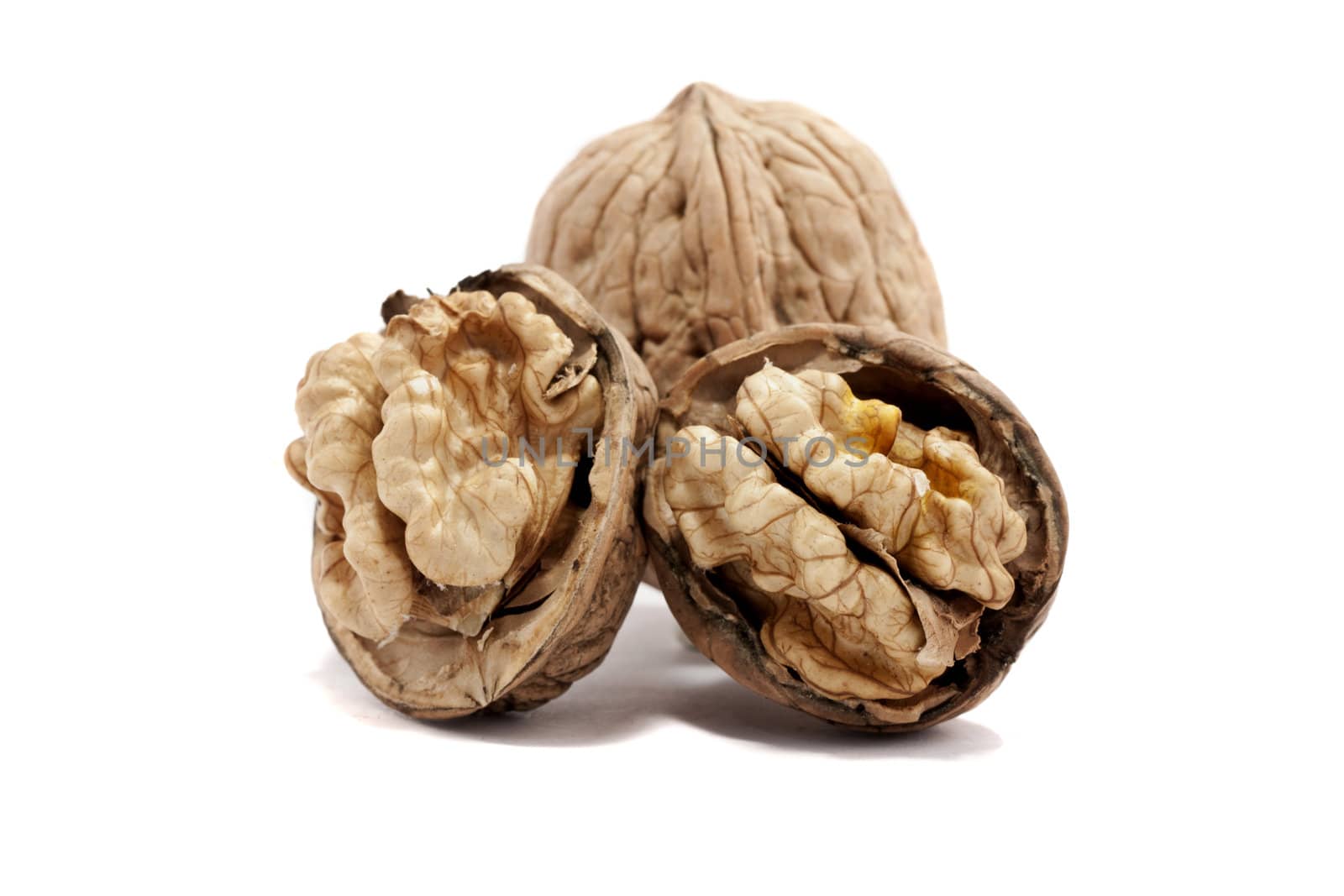 close view detail of  some walnuts  isolated on a white background.