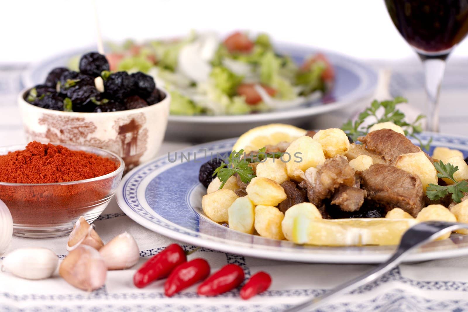 Close up view of a Portuguese meal of cooked meat with potatoes.