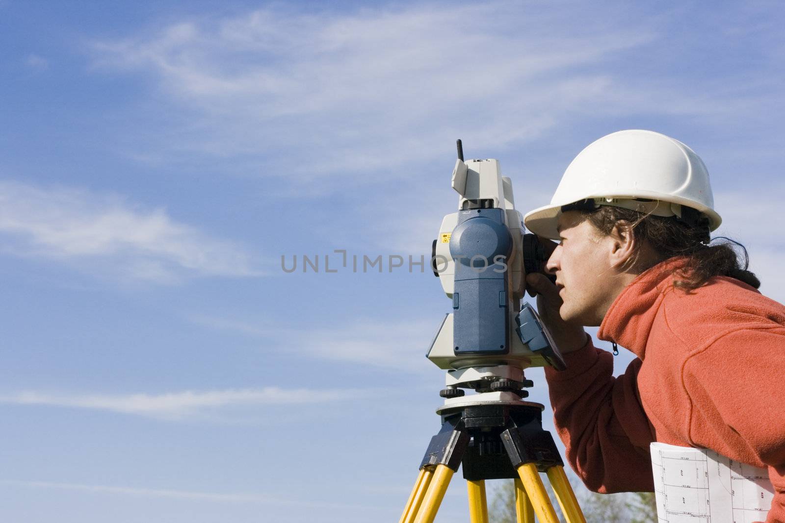 Measuring with theodolite - spring land surveying.