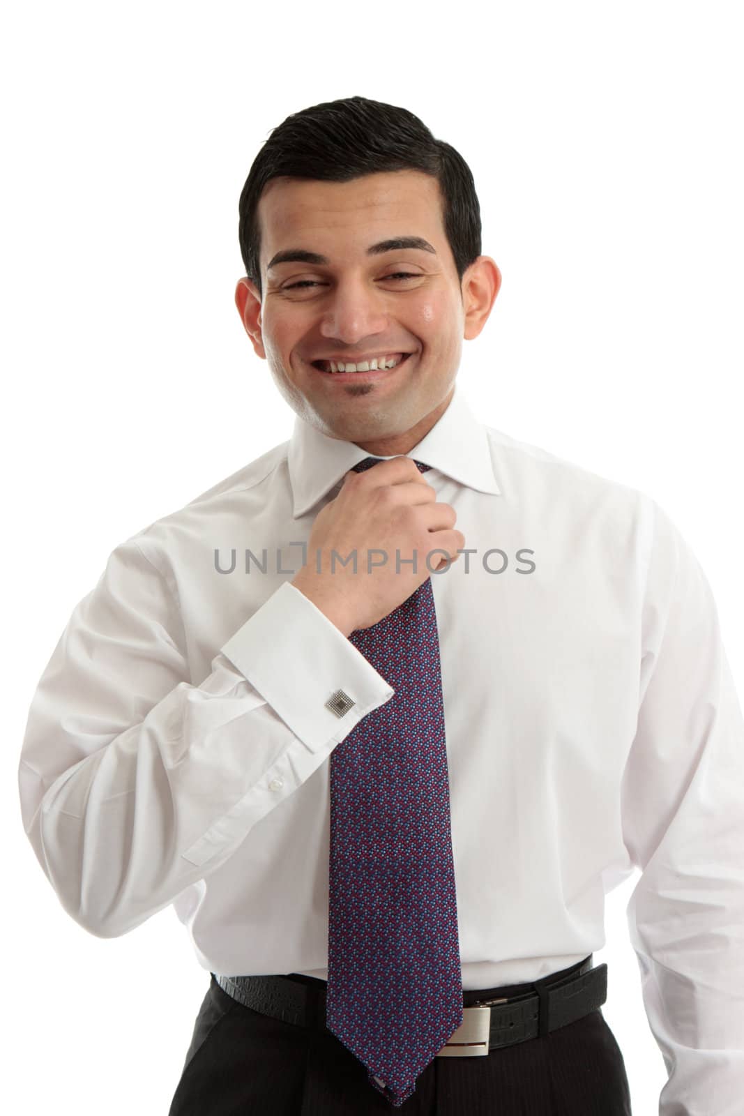 Happy businessman fixing or straightening tie.  White background.
