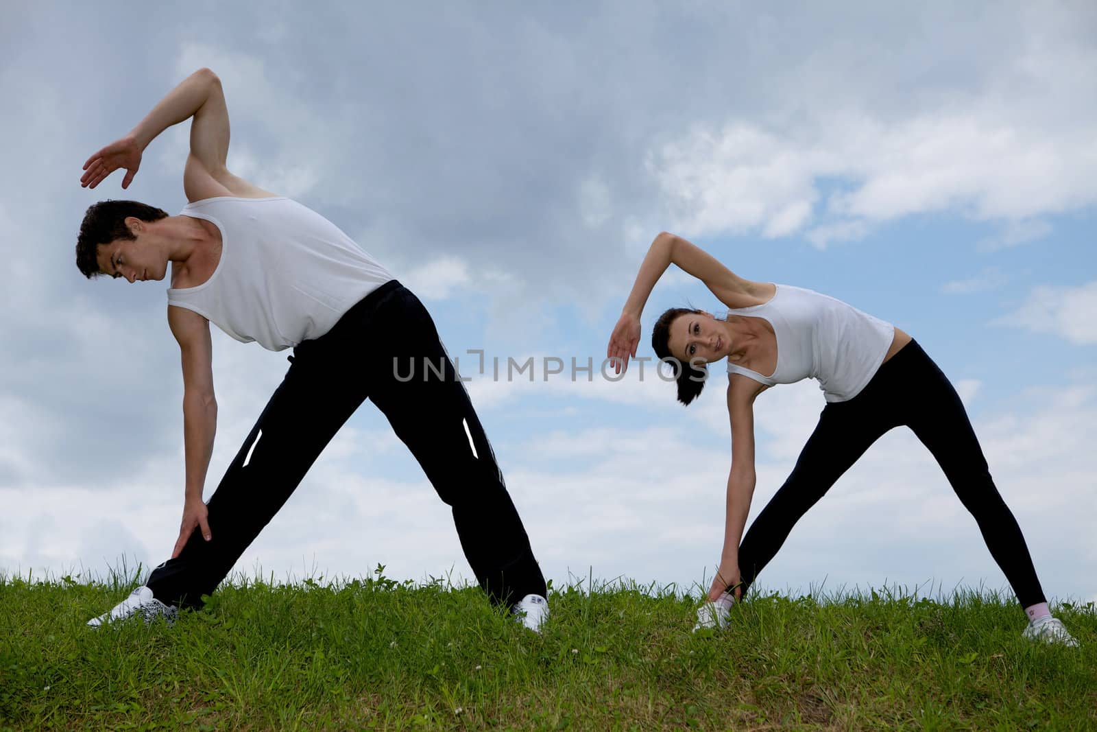 Young couple exercising in park by krzysiek_z_poczty