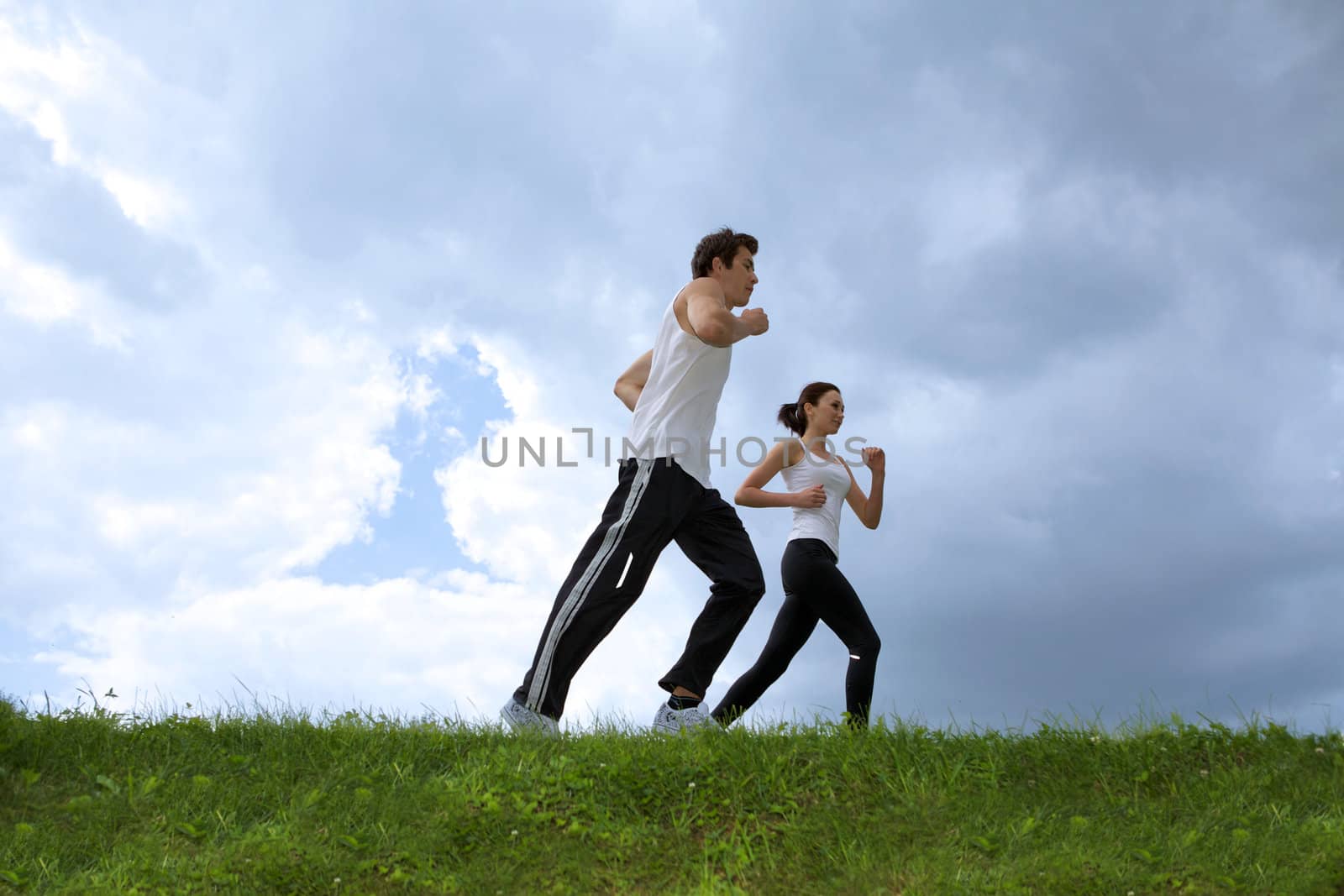 Young couple exercising in park by krzysiek_z_poczty