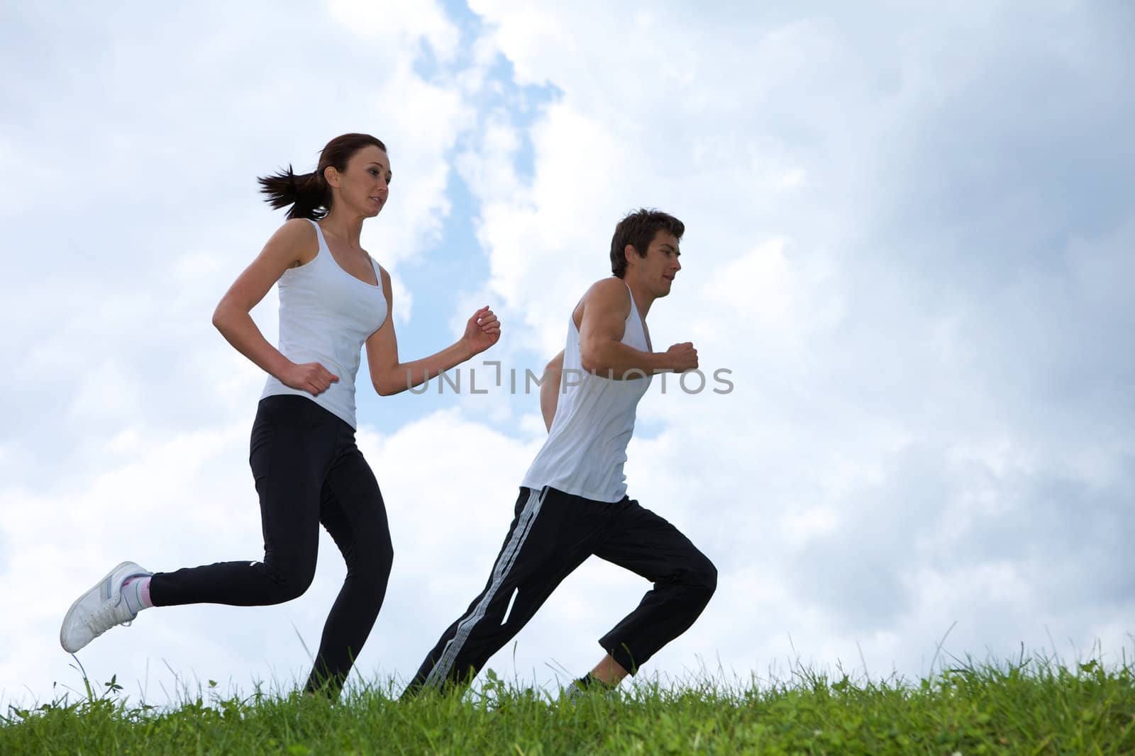 Young couple exercising in park by krzysiek_z_poczty