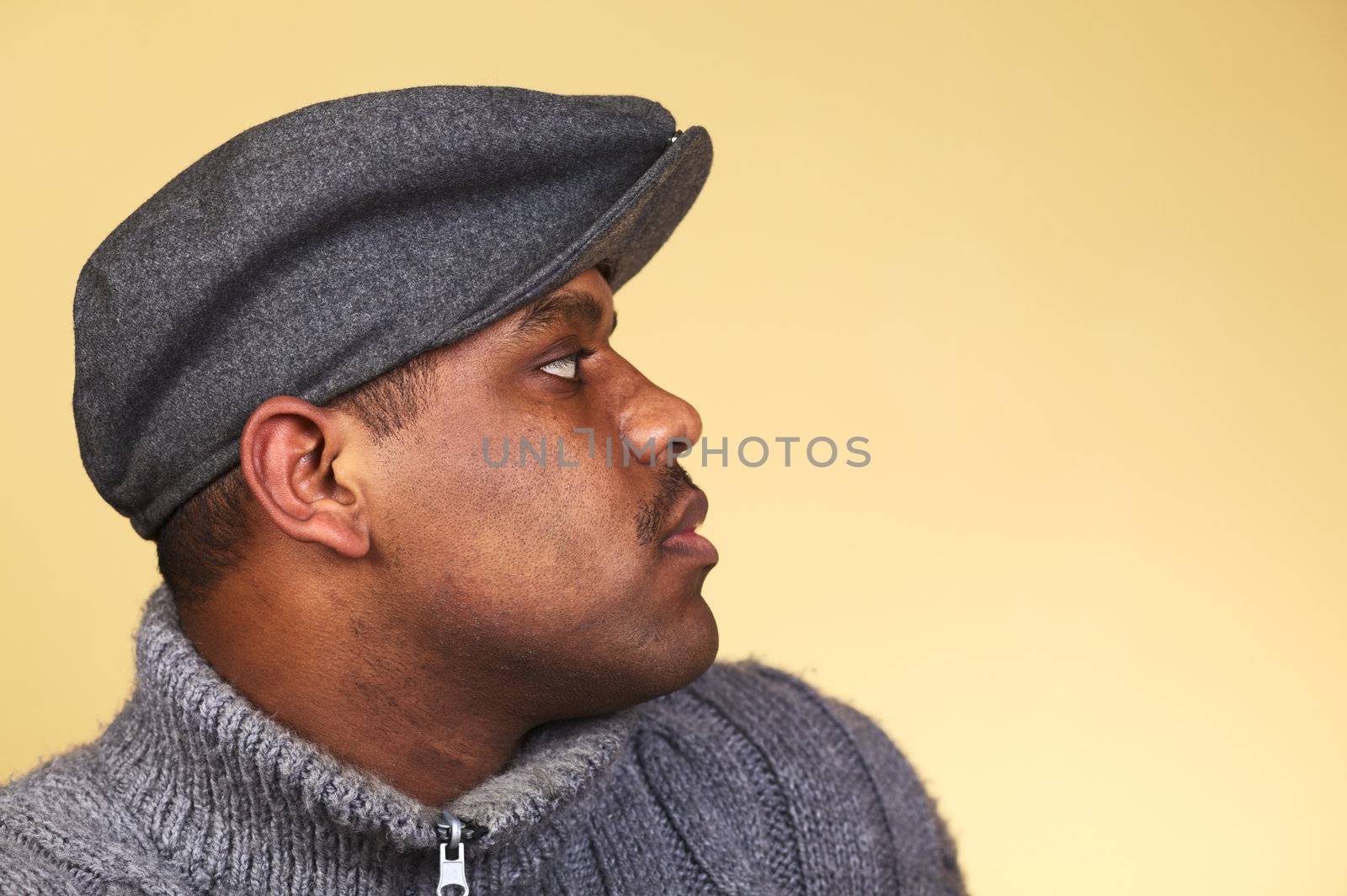 Portrait of a young man of African descent with a cap (Selective Focus, Focus on the eye)