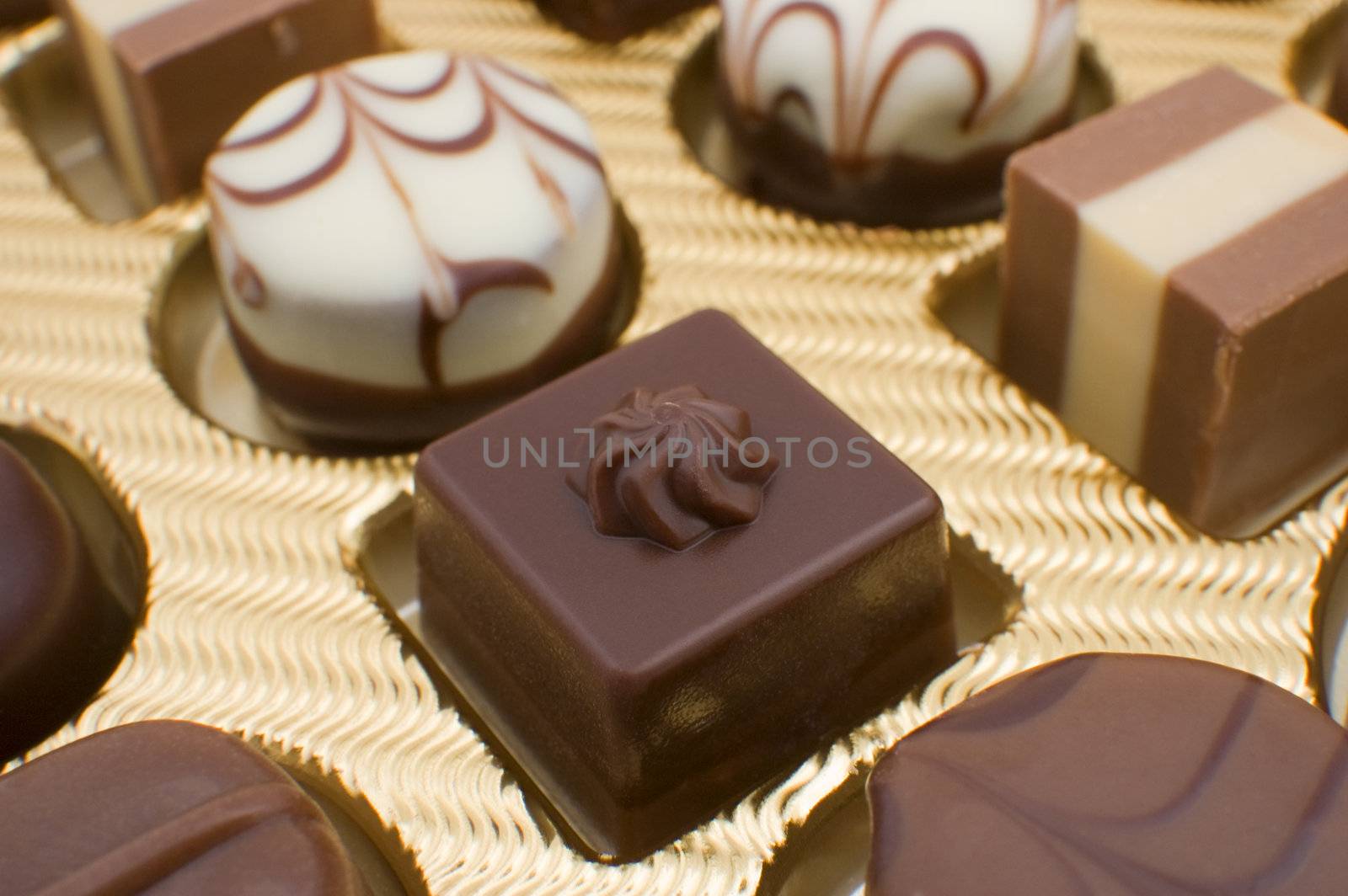 Detail of golden box filled with chocolate pralines