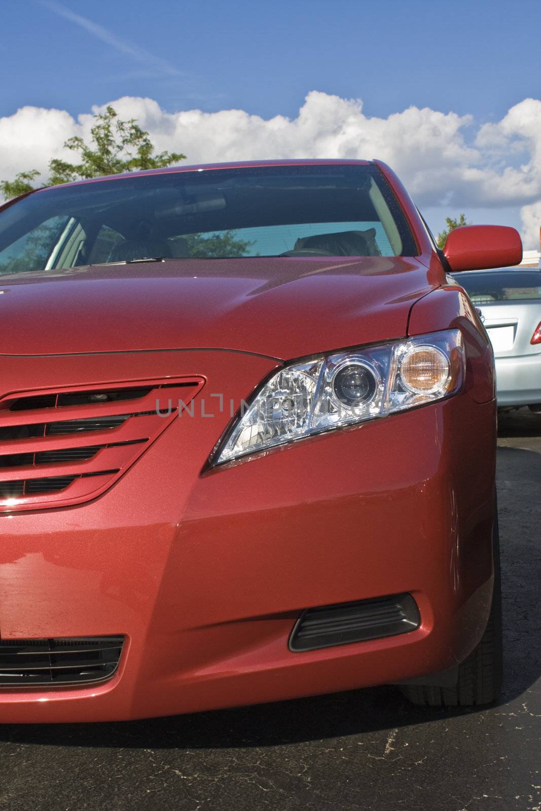 Front of a new, red Hybrid car.