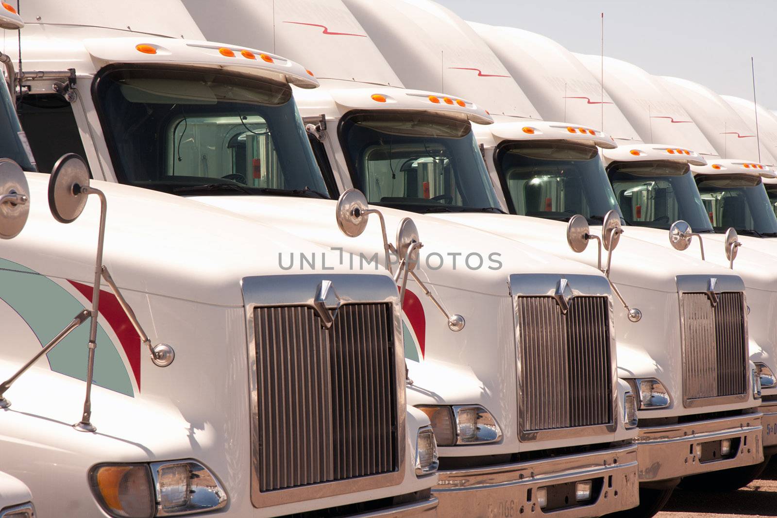 Semi truck fleet lined up in a row