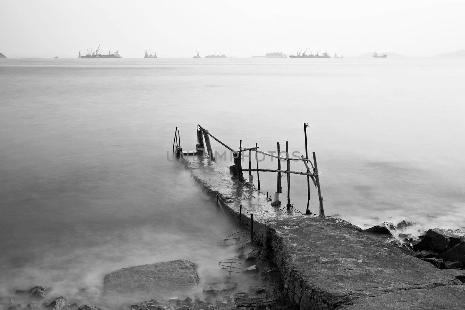 Jetty on sea at sunset