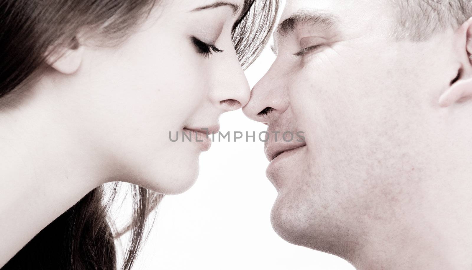 Studio shot of young loving couple caring