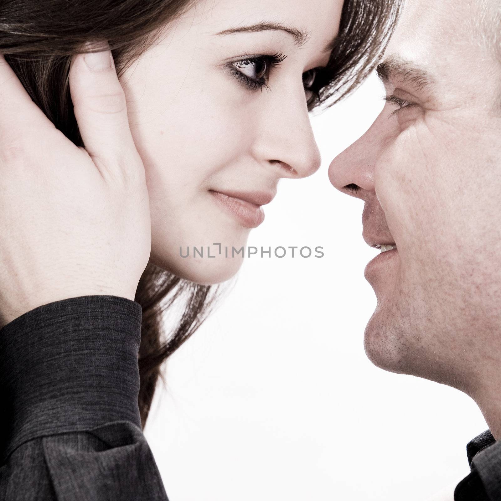Studio shot of young loving couple caring