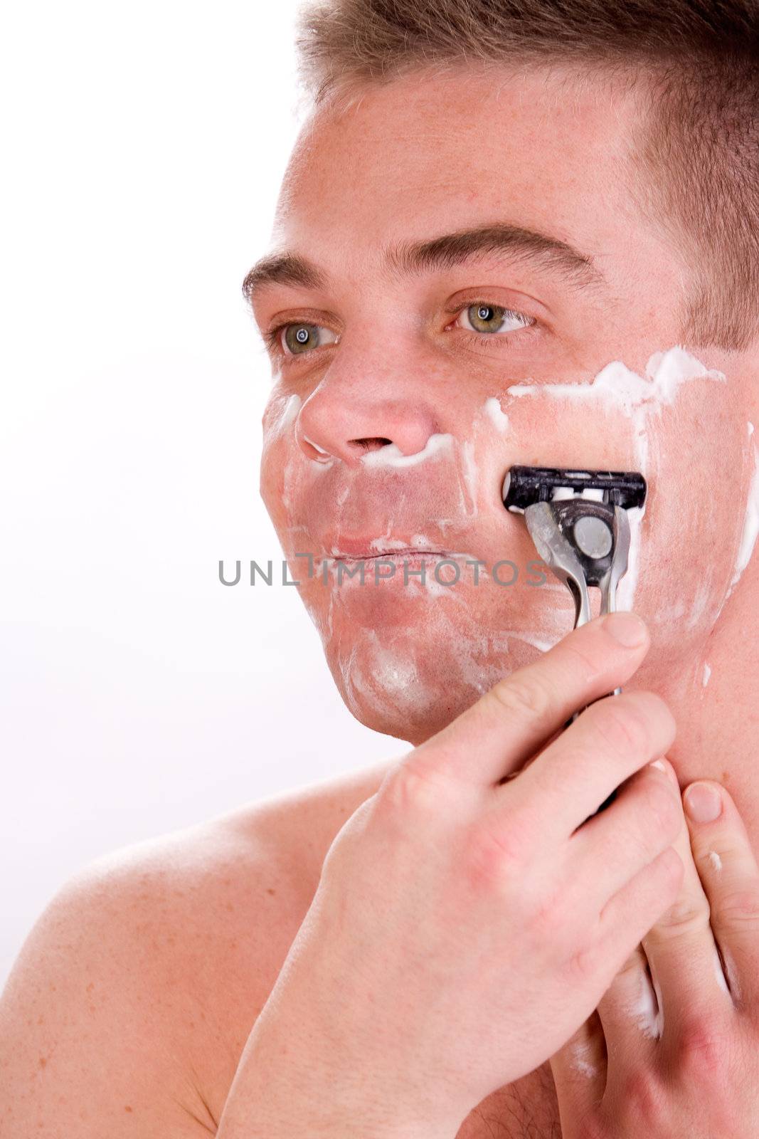 Young man with shaving foam on his face