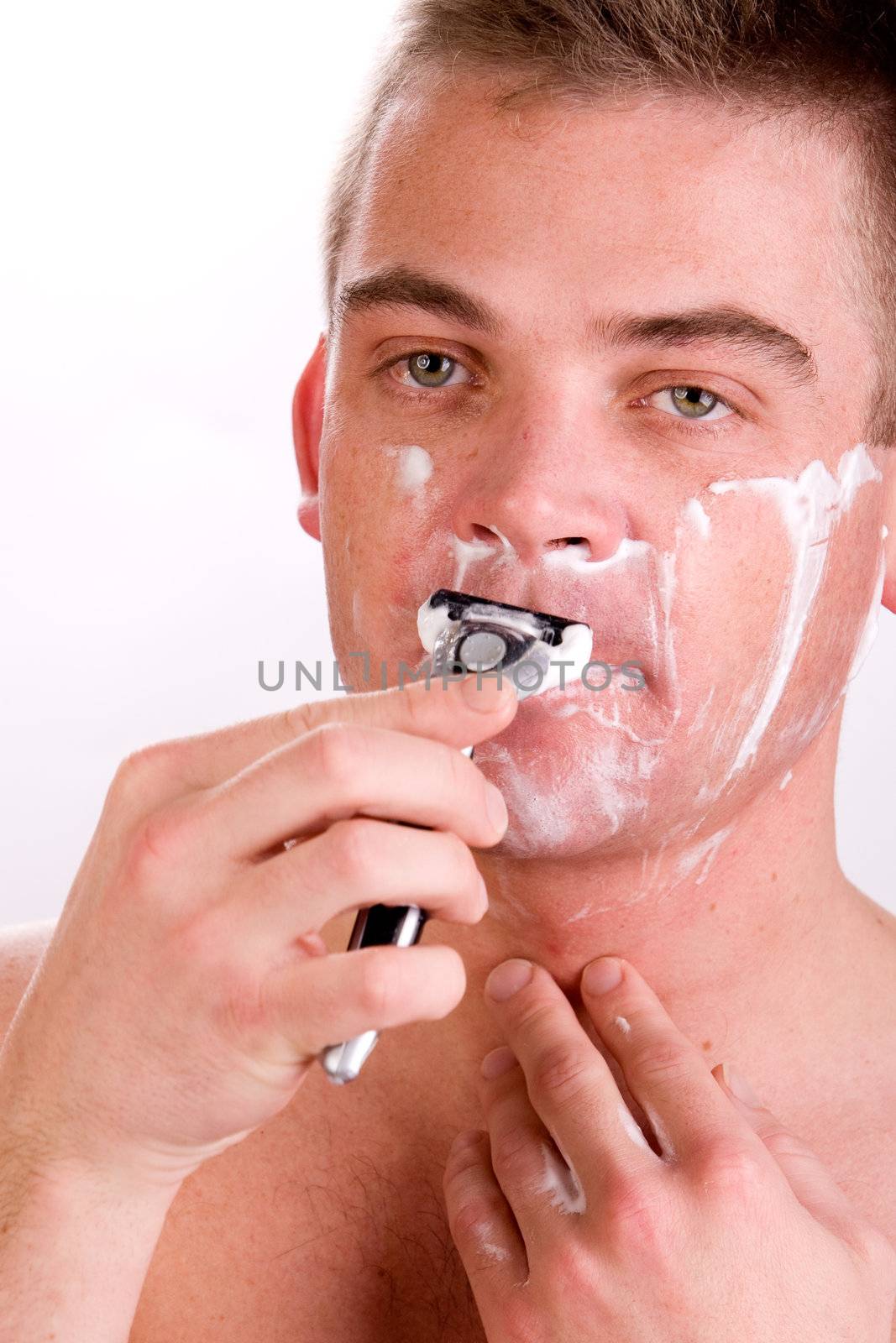 Young man with shaving foam on his face