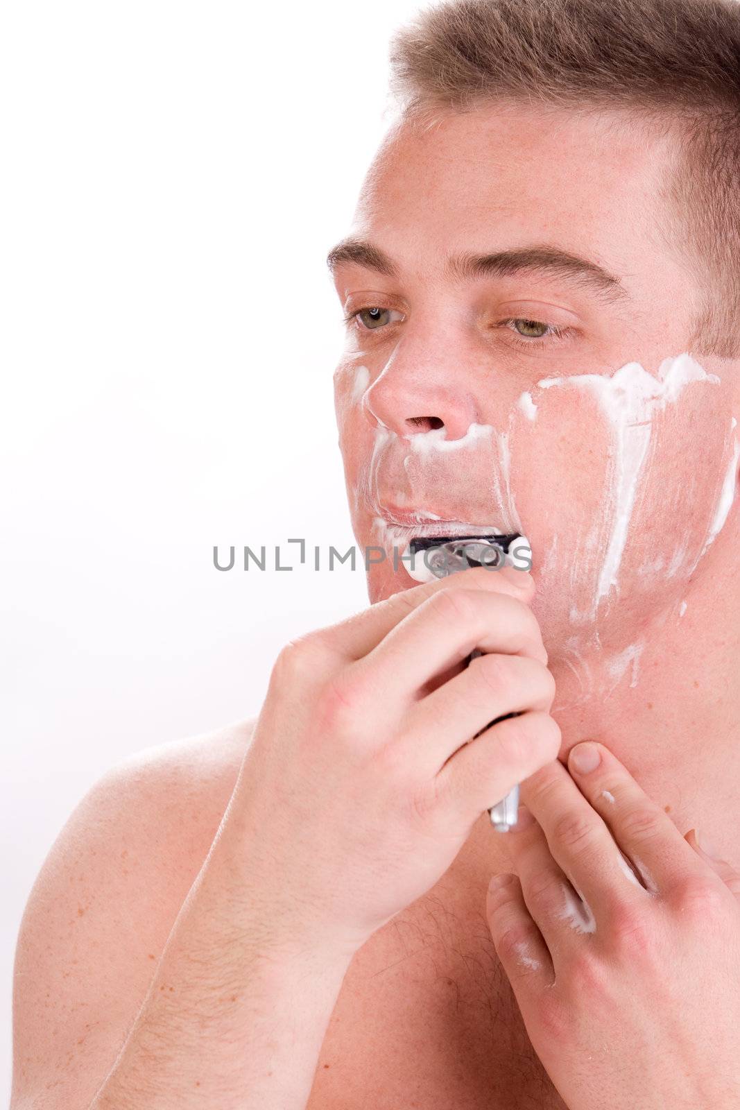 Young man with shaving foam on his face