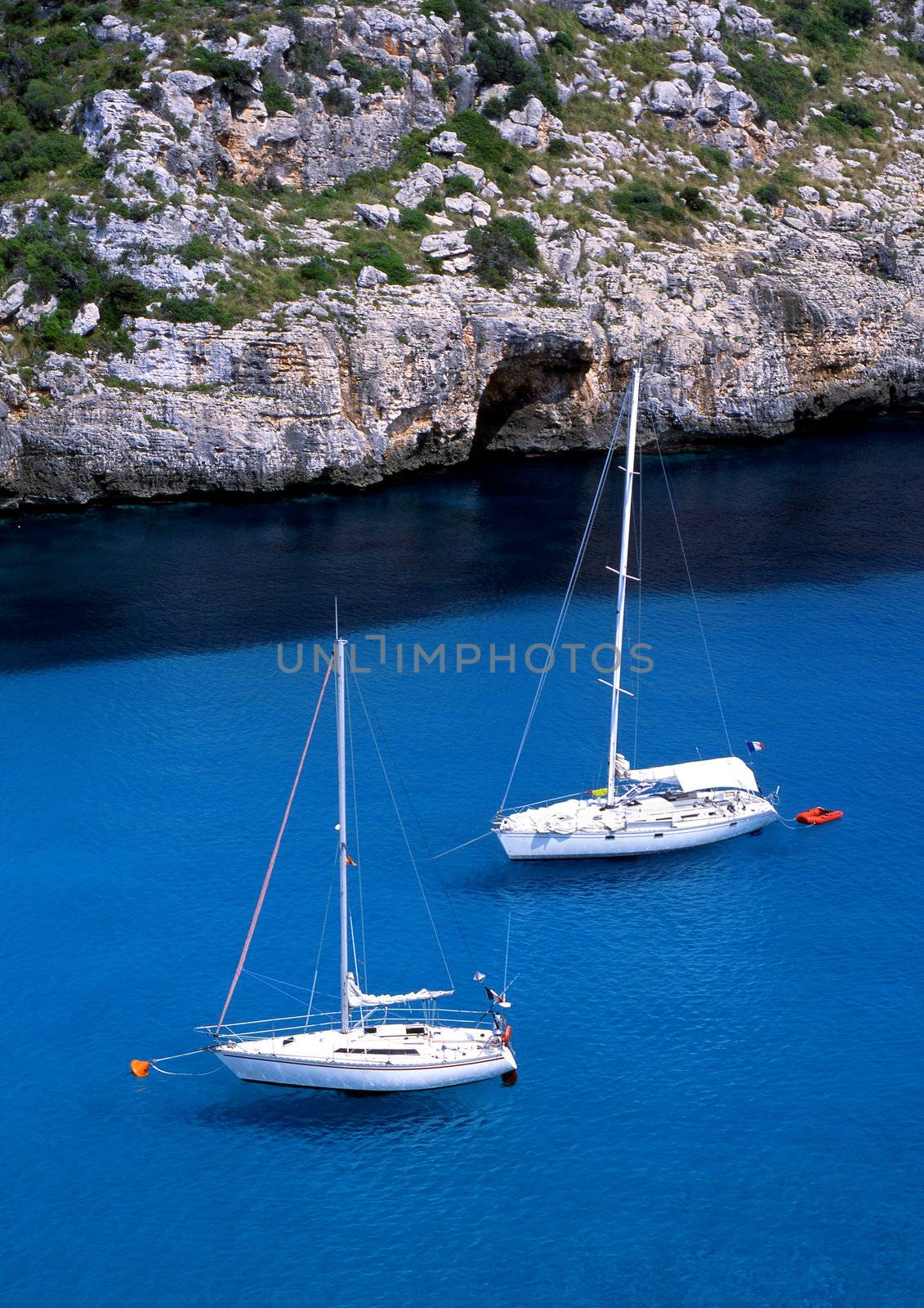 Two sail boats in the bay of Paleokastritsa on the greek island of Corfu