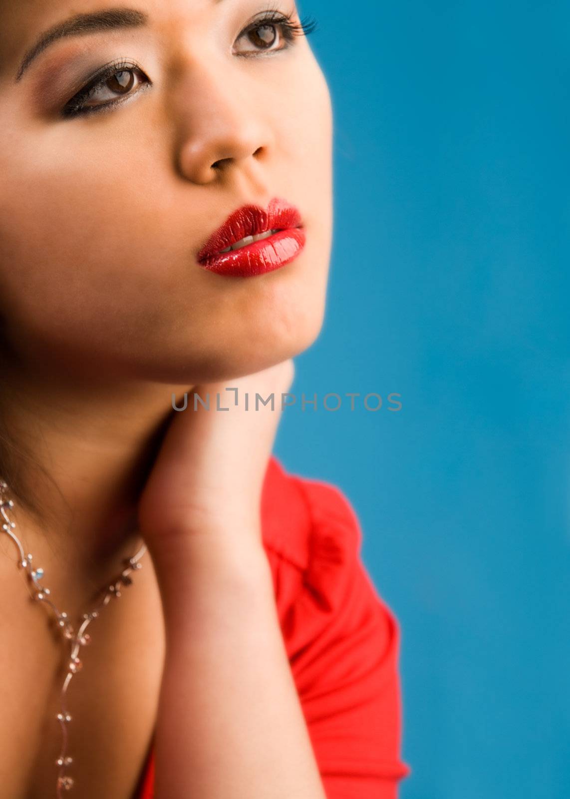 Young chinese girl on a blue background