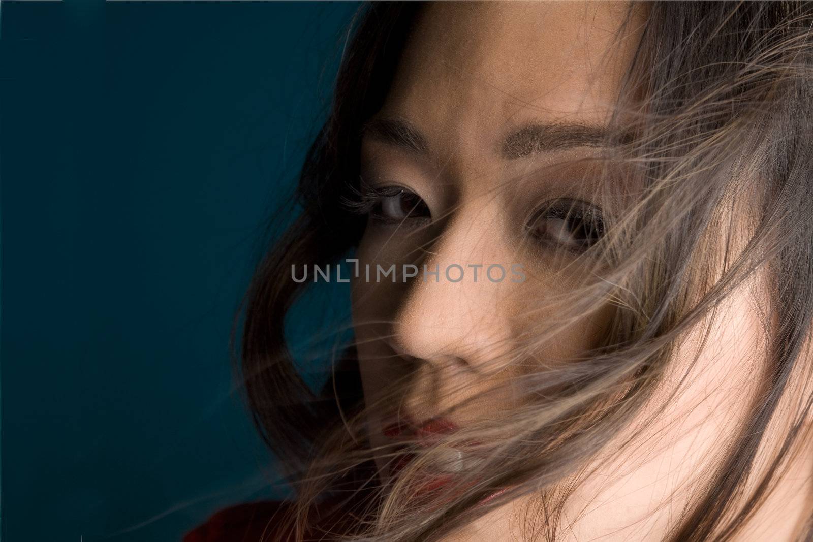 Young chinese girl on a dark background