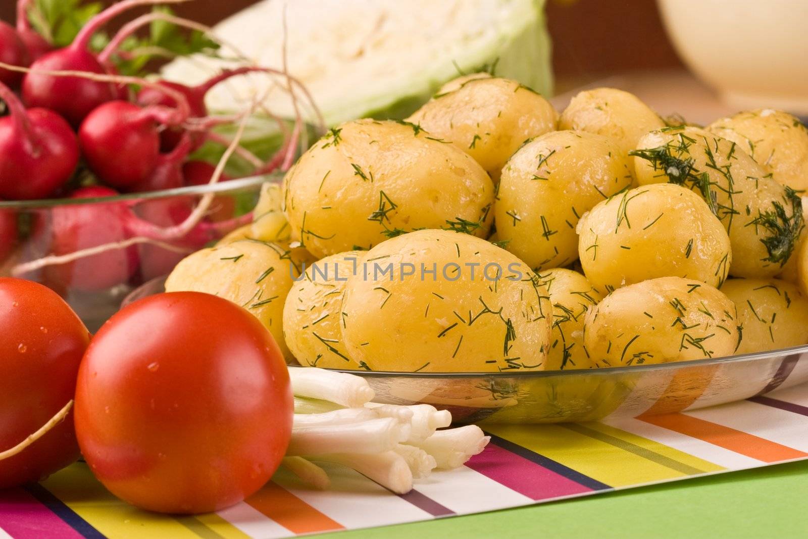 vegetarian food: cooked potatoes, tomato, spring onions and garden radish