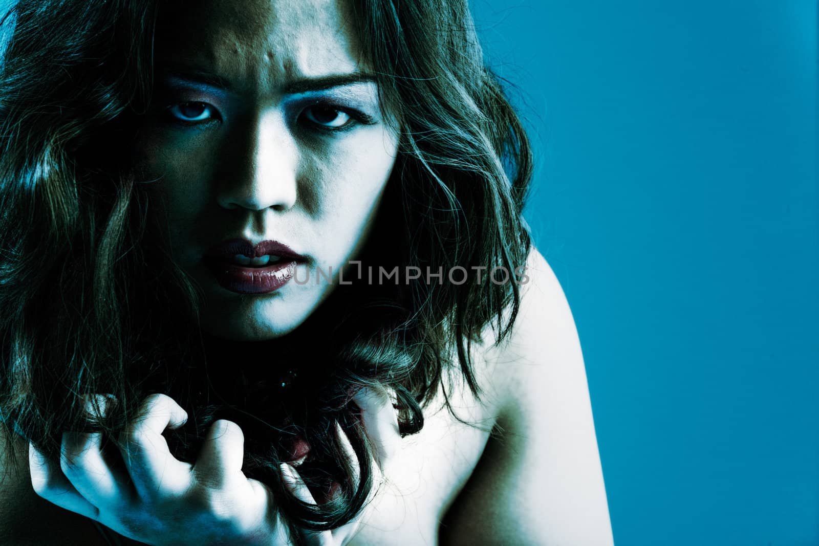 Young chinese girl on a blue background