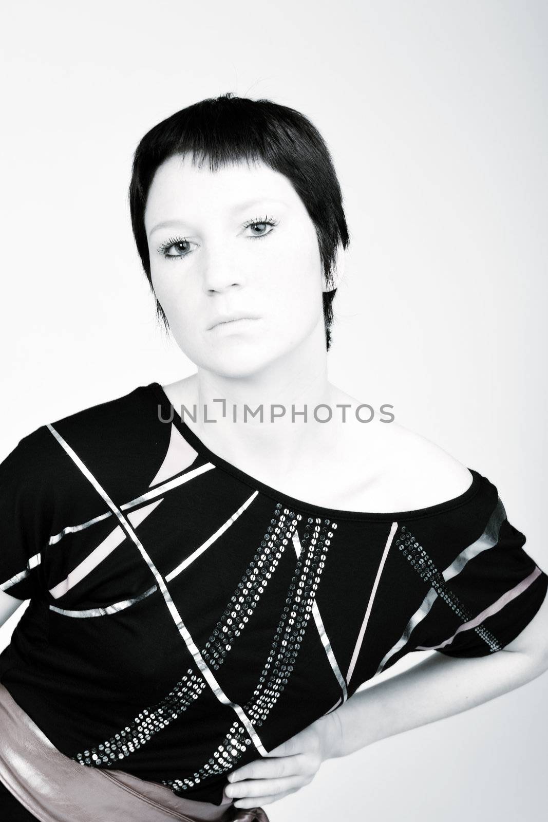 Studio portrait of a young woman with short hair in a fashion pose