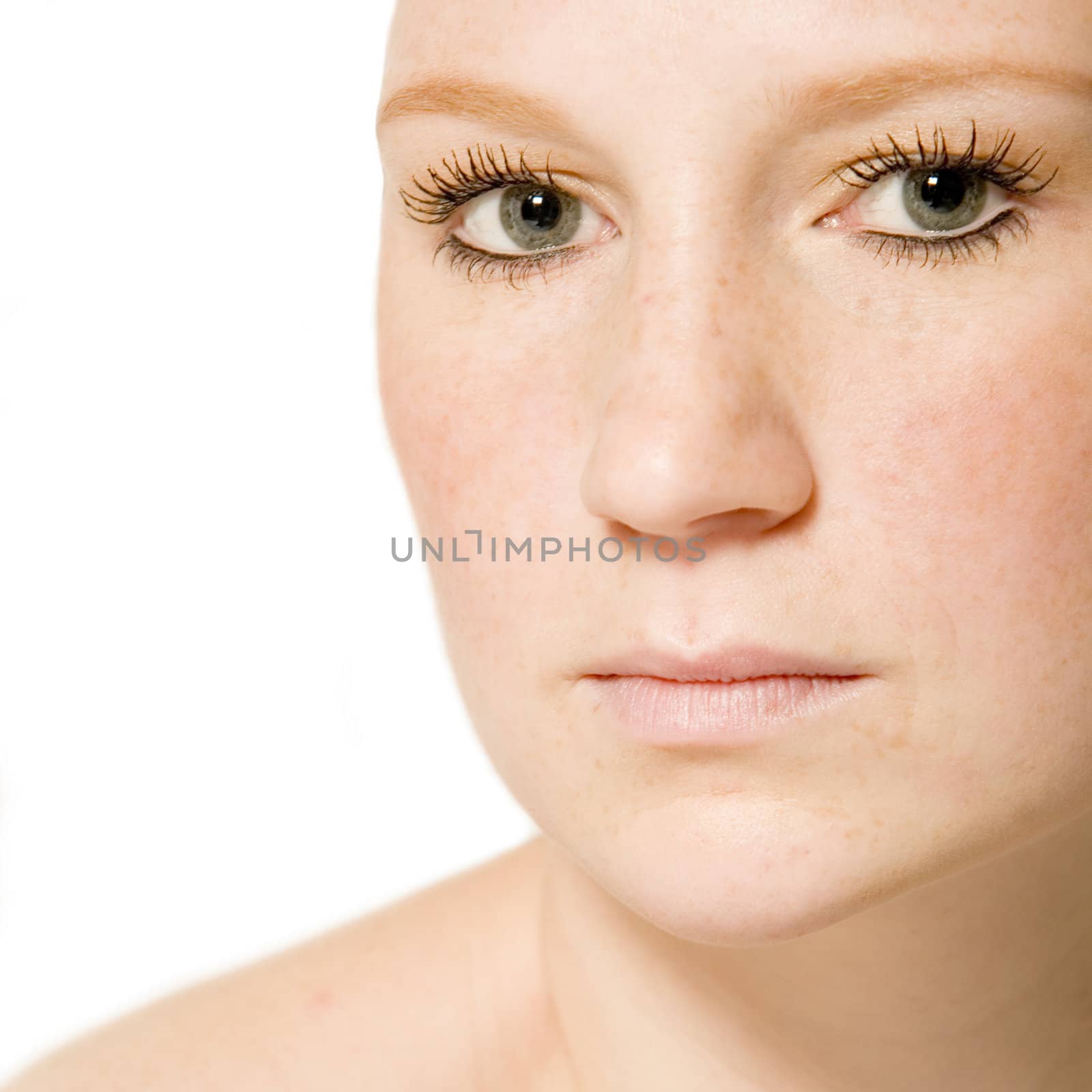 Studio portrait of a young woman with short hair looking thoughtful