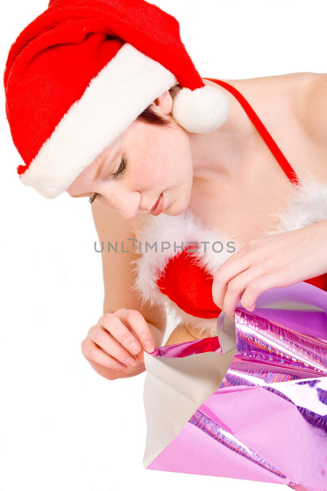 Beautiful girl dressed in a christmas lingerie set unwrapping a gift box
With clipping path for your convenience