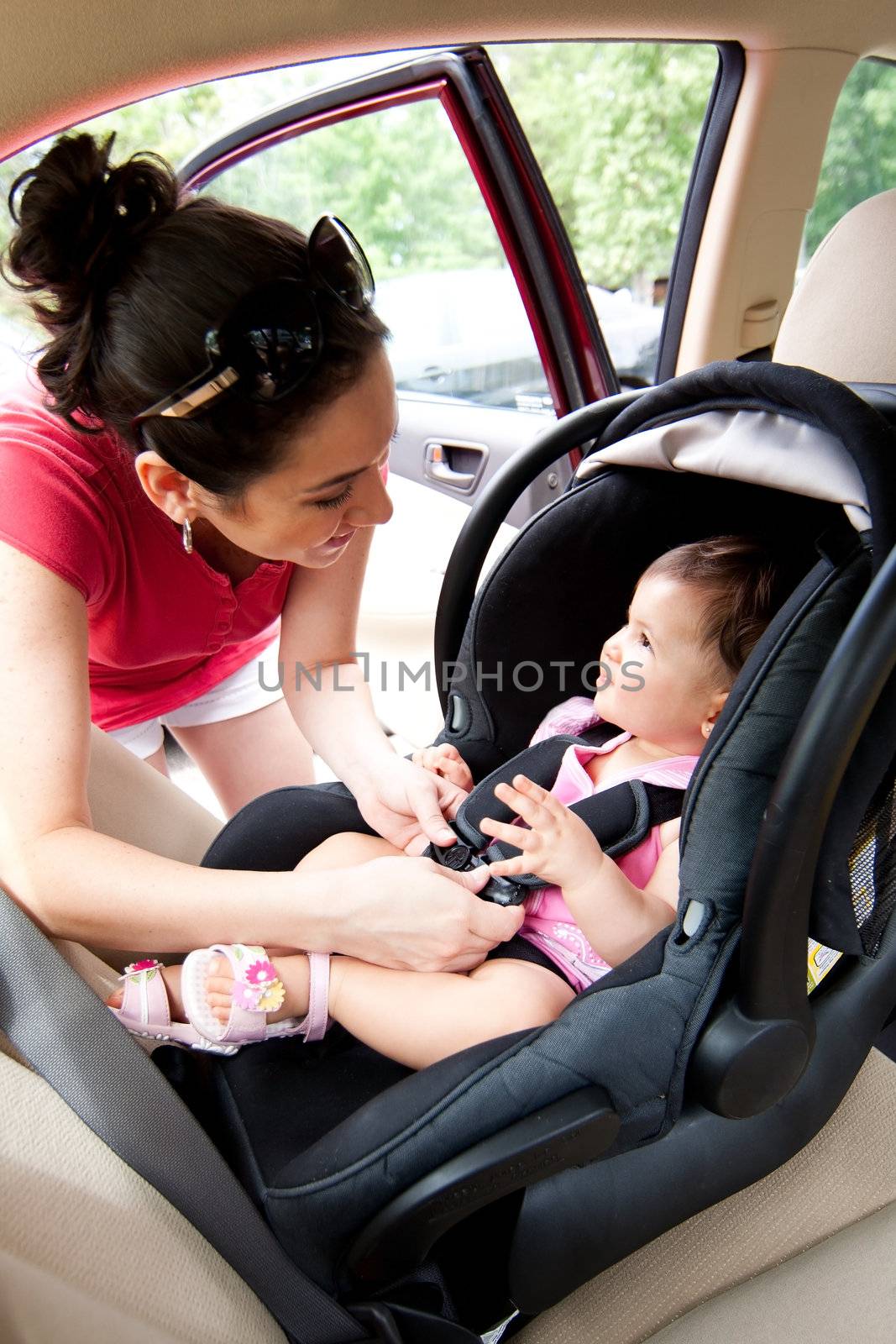 Baby in car seat for safety by phakimata