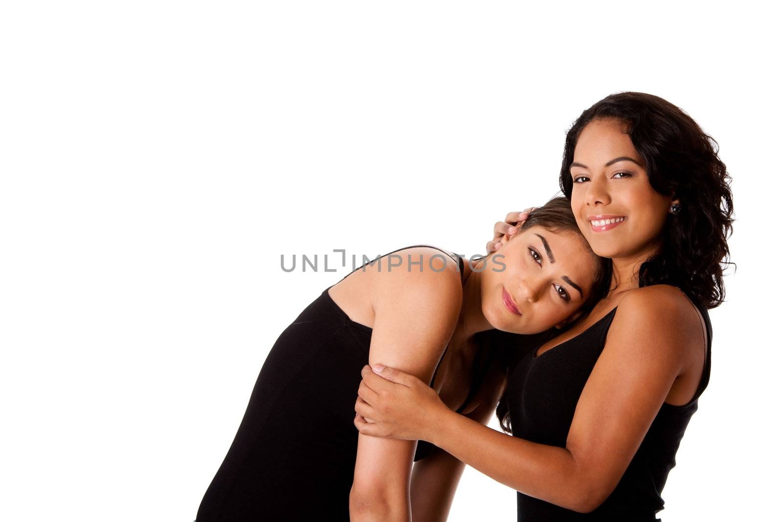 Beautiful happy young woman couple together with face resting on chest of other calming her, both dressed in black, isolated.