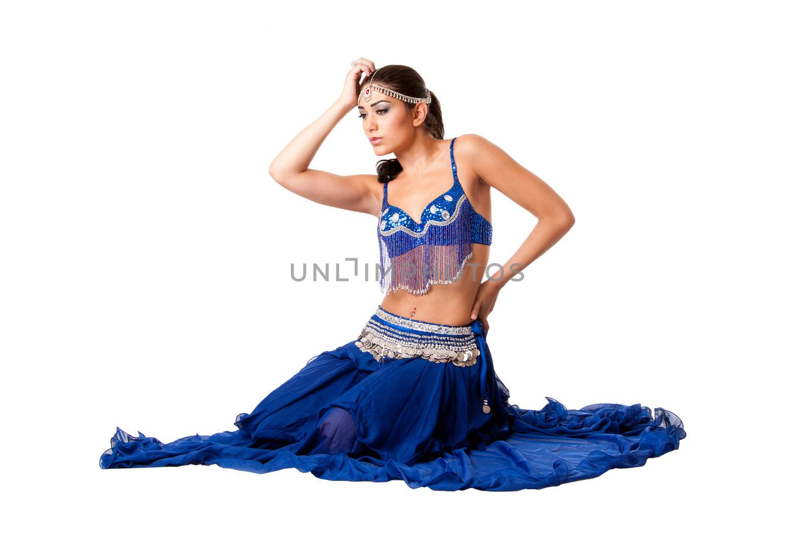 Beautiful Israeli Egyptian Lebanese Middle Eastern fashion belly dancer performer in blue skirt and bra with hand holding head, isolated.