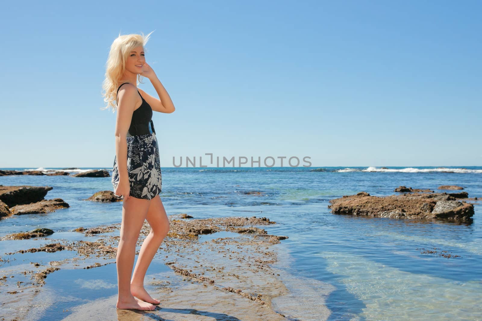 beautiful young woman enjoying summer vacation at the beach 