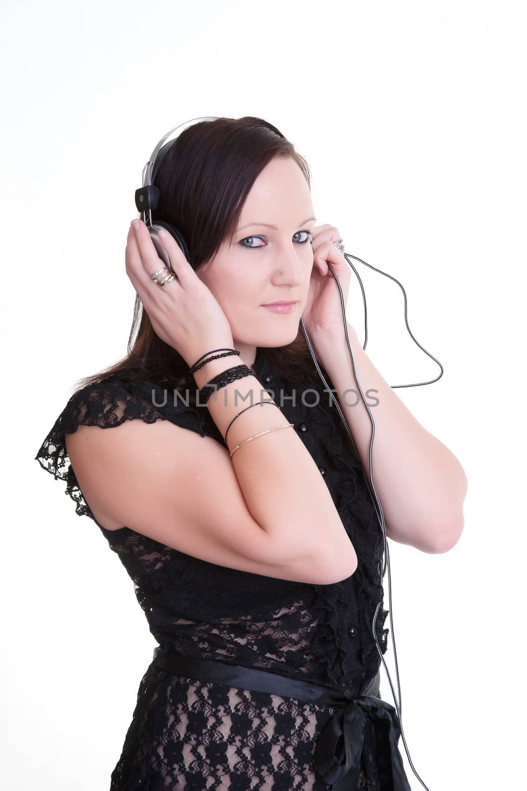 pretty young woman listening to headphones isolated on white