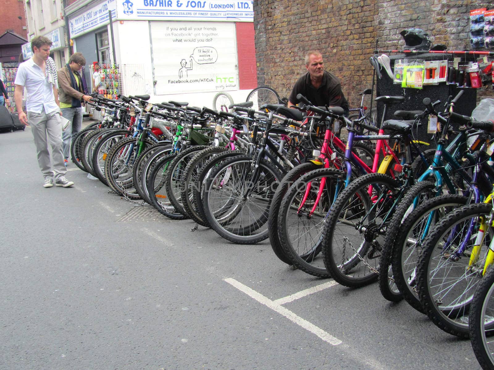 Unidentified visitors near a bike sellers stand at Brick Lane Ma by green308