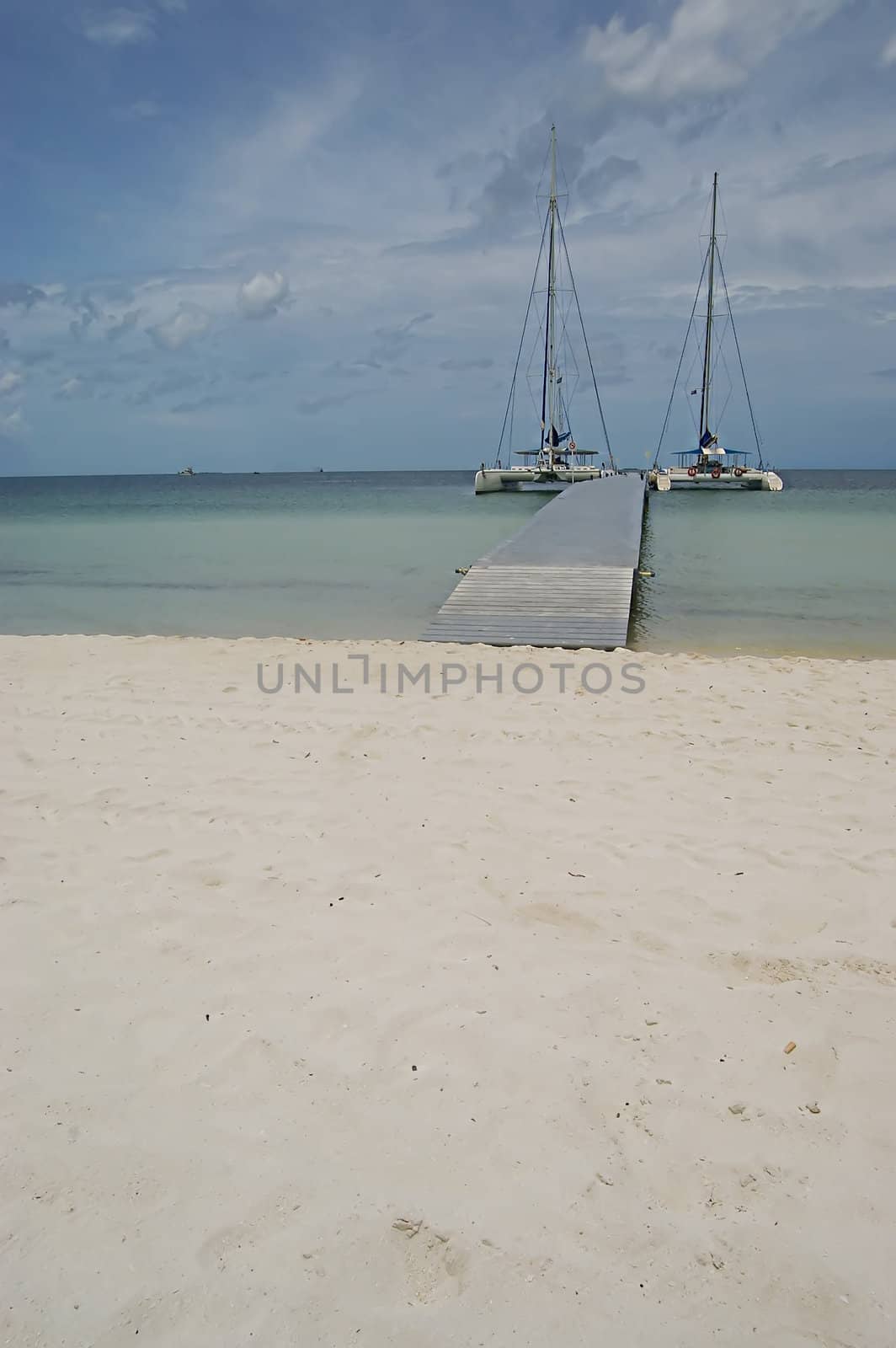 Two catamarans tied to the long landing stage