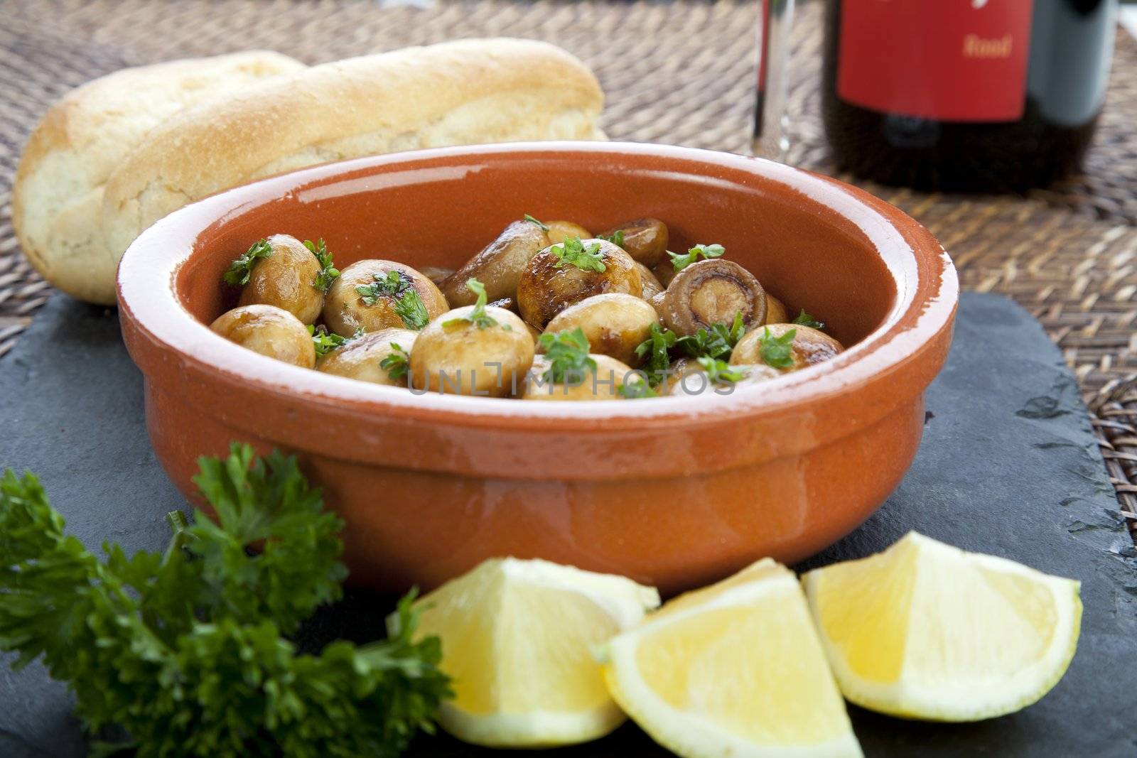 Fresh marinated mushroom tapas with lemon and bread.