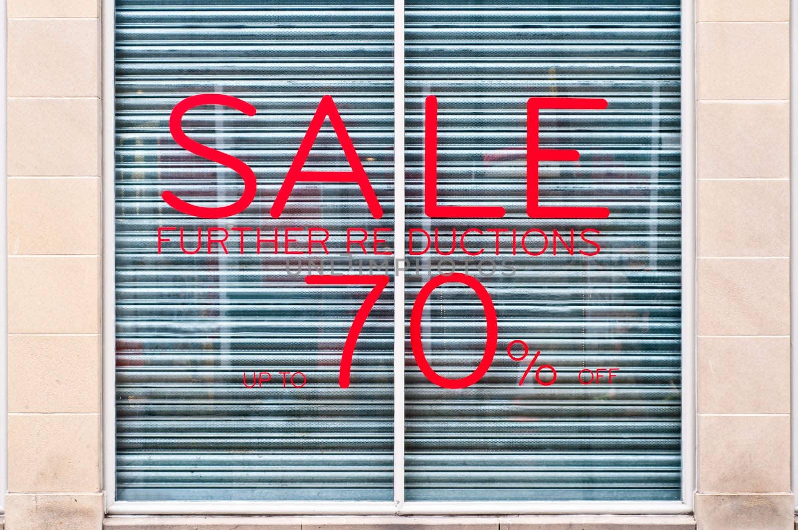 photograph of 70% sale sign on a shop windoow