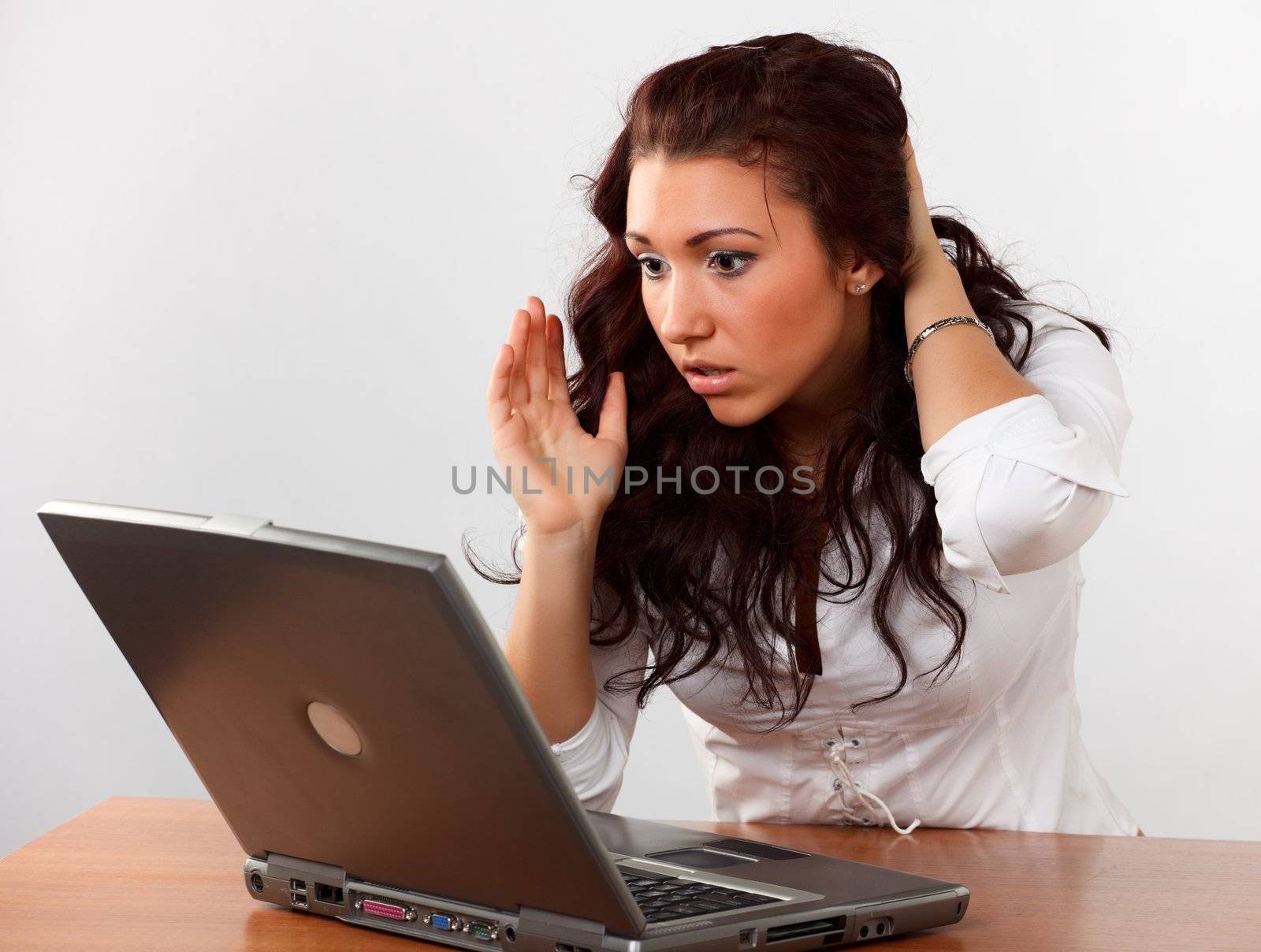 Young woman surfing the Internet on a laptop.