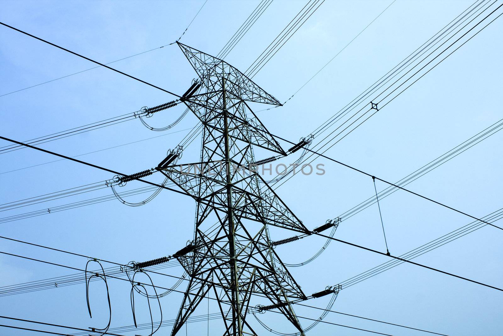 transmission tower with blue toned at day